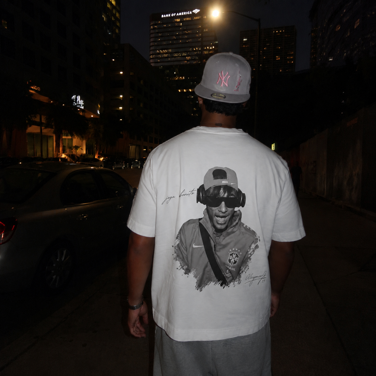 Model wearing the Joga Bonito tee at night in the city