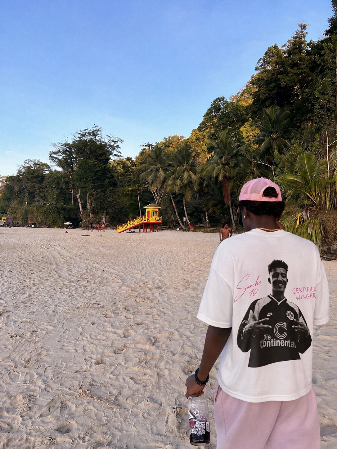 Model wearing the Pressure Builds Diamonds tee at the beach