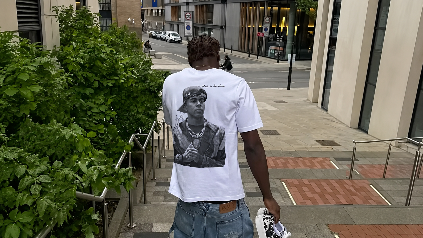 Model outside a house wearing the Pressure Builds Diamonds tee
